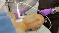 A medical professional demonstrates on a manikin.